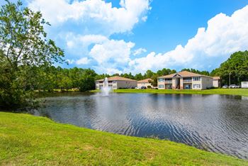 A peaceful pond with a large fountain display.